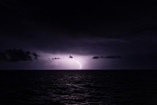 A lightning strikes over the Mediterranean Sea during a thunderstorm on December 29, 2025. (Photo by Sameer Al-DOUMY / AFP)