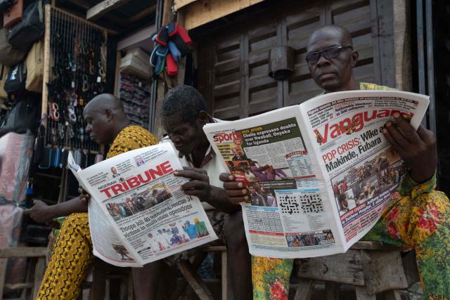 Residents read newspapers bearing headlines about a road accident involving British boxer Anthony Joshua, who was hospitalized in stable condition after a crash that killed two people, in Abeokuta on December 30, 2025. Former world heavyweight boxing champion Anthony Joshua was in a "stable condition" in hospital after a car accident in Nigeria that killed two close friends and associates, his promoter announced on December 29, 2025.
Matchroom confirmed police and media reports that he was involved in the smash, which happened on December 29, 2025 morning on a main road linking Lagos and Ibadan in the southwest of the country. (Photo by TOYIN ADEDOKUN / AFP)