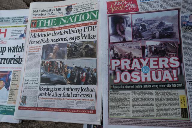 Newspapers bearing headlines about a road accident involving British boxer Anthony Joshua, who was hospitalized in stable condition after a crash that killed two people, are displayed at a stall in Abeokuta on December 30, 2025. Former world heavyweight boxing champion Anthony Joshua was in a "stable condition" in hospital after a car accident in Nigeria that killed two close friends and associates, his promoter announced on December 29, 2025.
Matchroom confirmed police and media reports that he was involved in the smash, which happened on December 29, 2025 morning on a main road linking Lagos and Ibadan in the southwest of the country. (Photo by TOYIN ADEDOKUN / AFP)
