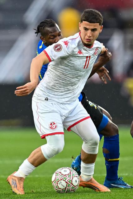 Tanzania's midfielder #27 Alphonce Msanga and Tunisia's midfielder #11 Ismael Gharbi vie during the Africa Cup of Nations (CAN) Group C football match between Tanzania and Tunisia at Rabat Olympic Stadium in Rabat on December 30, 2025. (Photo by Paul ELLIS / AFP)