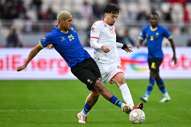 Tanzania's midfielder #25 Haji Mnoga and Tunisia's forward #26 Sebastian Tounekti vie during the Africa Cup of Nations (CAN) Group C football match between Tanzania and Tunisia at Rabat Olympic Stadium in Rabat on December 30, 2025. (Photo by Paul ELLIS / AFP)