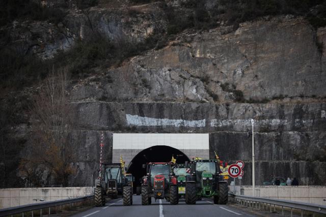 Farmers use tractors to block a tunnel, in Foix, south-western France, on December 30, 2025. (Photo by Valentine CHAPUIS / AFP)