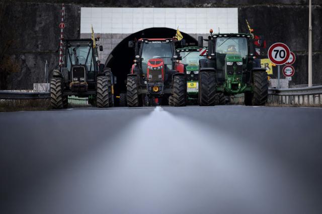 Farmers use tractors to block a tunnel, in Foix, south-western France, on December 30, 2025. (Photo by Valentine CHAPUIS / AFP)