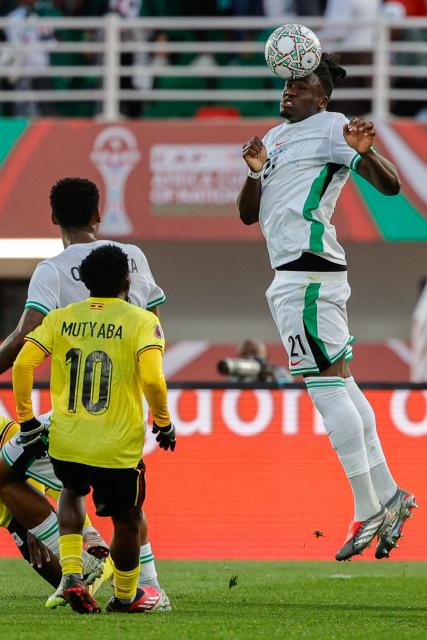 Nigeria's defender #21 Calvin Bassey heads the ball during the Africa Cup of Nations (CAN) Group C football match between Uganda and Nigeria at Fez Stadium in Fez on December 30, 2025. (Photo by Abdel Majid BZIOUAT / AFP)