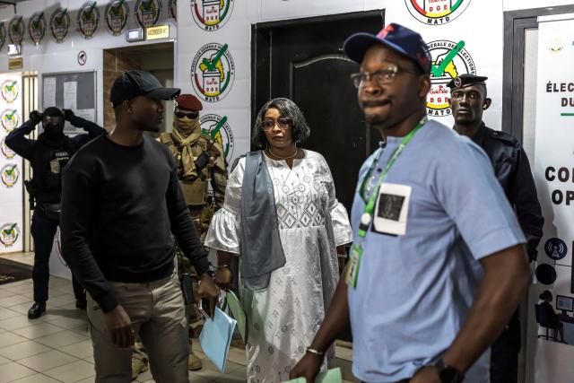 Head of the General Directorate of Elections (DGE) Djenabou Toure (C) arrives ahead of the announcement of official partial results at the DGE offices in Conakry, on December 30, 2025, during Guinea’s presidential election. Guinea's junta chief, who had pledged not to run for office after seizing power four years ago, has a large lead in presidential elections held at the weekend, according to initial results published late December 29. (Photo by PATRICK MEINHARDT / AFP)