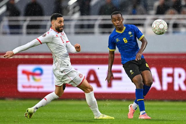 Tunisia's defender #06 Dylan Bronn and Tanzania's midfielder #06 Feisal Salum vie during the Africa Cup of Nations (CAN) Group C football match between Tanzania and Tunisia at Rabat Olympic Stadium in Rabat on December 30, 2025. (Photo by Paul ELLIS / AFP)