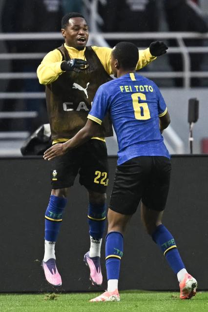 Tanzania's defender #22 Shomari Kapombe celebrates Tanzania's midfielder #06 Feisal Salum's goal during the Africa Cup of Nations (CAN) Group C football match between Tanzania and Tunisia at Rabat Olympic Stadium in Rabat on December 30, 2025. (Photo by Paul ELLIS / AFP)