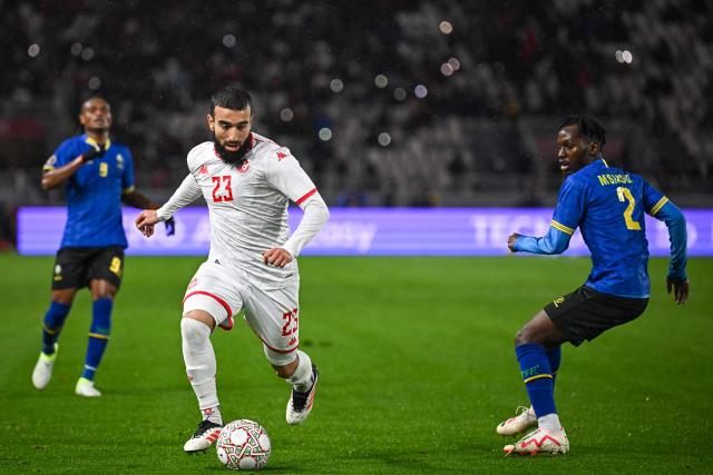 Tunisia's forward #23 Naim Sliti outpasses Tanzania's defender #02 Pascal Msindo during the Africa Cup of Nations (CAN) Group C football match between Tanzania and Tunisia at Rabat Olympic Stadium in Rabat on December 30, 2025. (Photo by Paul ELLIS / AFP)