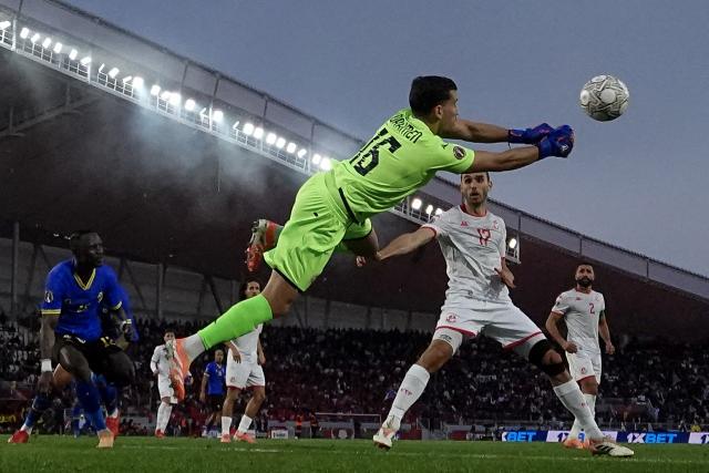Tunisia's goalkeeper #16 Aymen Dahmen makes a save during the Africa Cup of Nations (CAN) Group C football match between Tanzania and Tunisia at Rabat Olympic Stadium in Rabat on December 30, 2025. (Photo by Paul ELLIS / AFP)