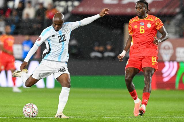 Botswana's midfielder #22 Gilbert Baruti and Democratic Republic Of Congo's midfielder #06 Ngal'ayel Mukau vie during the Africa Cup of Nations (CAN) Group D football match between Botswana and Democratic Republic of Congo at El Madina Stadium in Rabat on December 30, 2025. (Photo by SEBASTIEN BOZON / AFP)