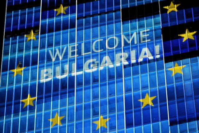 A "Welcome Bulgaria!" projection is pictured on the facade of the European Central Bank (ECB) headquarters in Frankfurt am Main, western Germany, on December 30, 2025 as a preview of the ECB main building illumination in celebration of Bulgaria’s accession to the euro area. (Photo by Kirill KUDRYAVTSEV / AFP)