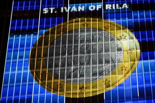 A projection of a Bulgarian Euro coin is pictured on the facade of the European Central Bank (ECB) headquarters in Frankfurt am Main, western Germany, on December 30, 2025 as a preview of the ECB main building illumination in celebration of Bulgaria’s accession to the euro area. (Photo by Kirill KUDRYAVTSEV / AFP)