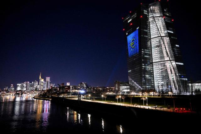 A projection of a Euro currency sign is pictured on the facade of the European Central Bank (ECB) headquarters in Frankfurt am Main, western Germany, on December 30, 2025 as a preview of the ECB main building illumination in celebration of Bulgaria’s accession to the euro area. (Photo by Kirill KUDRYAVTSEV / AFP)