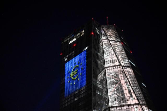 A projection of a Euro currency sign is pictured on the facade of the European Central Bank (ECB) headquarters in Frankfurt am Main, western Germany, on December 30, 2025 as a preview of the ECB main building illumination in celebration of Bulgaria’s accession to the euro area. (Photo by Kirill KUDRYAVTSEV / AFP)