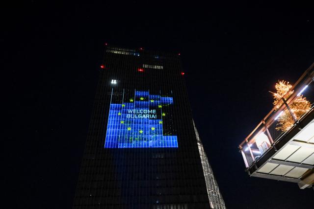 A projection reading "Welcome Bulgaria!" is pictured on the facade of the European Central Bank (ECB) headquarters in Frankfurt am Main, western Germany, on December 30, 2025 as a preview of the ECB main building illumination in celebration of Bulgaria’s accession to the euro area. (Photo by Kirill KUDRYAVTSEV / AFP)
