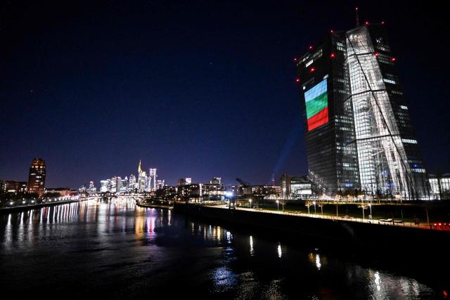 A projection of Bulgaria's national flag is pictured on the facade of the European Central Bank (ECB) headquarters in Frankfurt am Main, western Germany, on December 30, 2025 as a preview of the ECB main building illumination in celebration of Bulgaria’s accession to the euro area. (Photo by Kirill KUDRYAVTSEV / AFP)