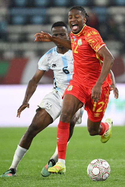 Botswana's midfielder #06 Gape Mohutsiwa and Democratic Republic Of Congo's defender #12 Joris Kayembe vie during the Africa Cup of Nations (CAN) Group D football match between Botswana and Democratic Republic of Congo at El Madina Stadium in Rabat on December 30, 2025. (Photo by SEBASTIEN BOZON / AFP)