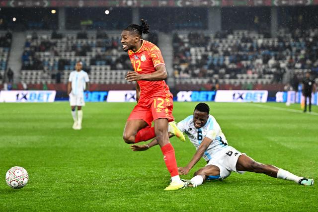 Democratic Republic Of Congo's defender #12 Joris Kayembe and Botswana's midfielder #06 Gape Mohutsiwa vie during the Africa Cup of Nations (CAN) Group D football match between Botswana and Democratic Republic of Congo at El Madina Stadium in Rabat on December 30, 2025. (Photo by SEBASTIEN BOZON / AFP)