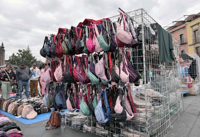 View of bags made in China at a street vendor's stand in front of the National Palace in Mexico City on December 30, 2025. Starting January 1, 2026, approximately 500,000 products from China and other Asian countries will be subject to new tariffs ranging from 5% to 50%, following the update of the General Import and Export Tax Law. (Photo by Alfredo ESTRELLA / AFP)