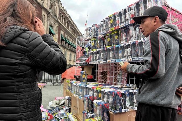 Toys made in China are displayed at a street vendor's stand in front of the National Palace in Mexico City on December 30, 2025. Starting January 1, 2026, approximately 500,000 products from China and other Asian countries will be subject to new tariffs ranging from 5% to 50%, following the update of the General Import and Export Tax Law. (Photo by Alfredo ESTRELLA / AFP)