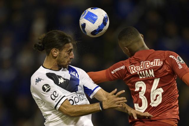 (FILES) Argentina's Velez Uruguayan Sebastian Sosa (L) and Brazil's Red Bull Bragantino Luan Candido jump for a header during their Copa Libertadores group stage first leg football match, at the Jose Amalfitani stadium in Liniers, Buenos Aires, on April 14, 2022. On December 30, 2025, an Argentine court dismissed charges against four footballers accused of sexually abusing a journalist while they played for premier division club Velez Sarsfield last year. The case arose after a 24-year-old sports journalist alleged she was raped after being invited by Uruguay international Sebastian Sosa to a hotel room in Tucuman, Argentina, in March 2024. She said Paraguayan midfielder Jose Florentin and Argentines Braian Cufre and Abiel Osorio were waiting in the room. (Photo by Juan MABROMATA / AFP)