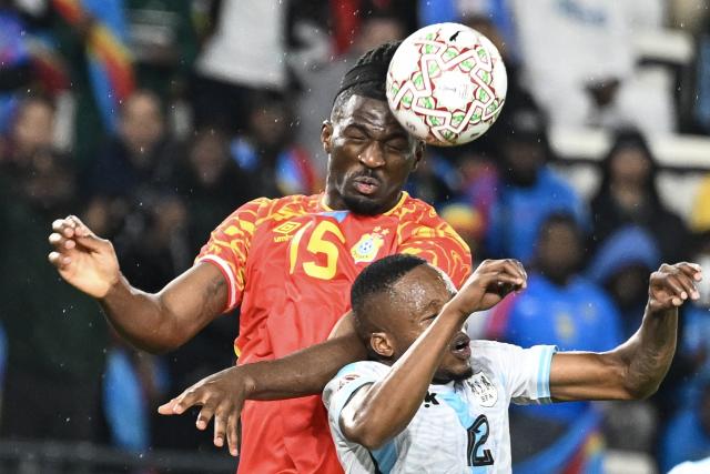 Democratic Republic Of Congo's defender #15 Rocky Bushiri and Botswana's defender #12 Mothusi Johnson vie during the Africa Cup of Nations (CAN) Group D football match between Botswana and Democratic Republic of Congo at El Madina Stadium in Rabat on December 30, 2025. (Photo by SEBASTIEN BOZON / AFP)