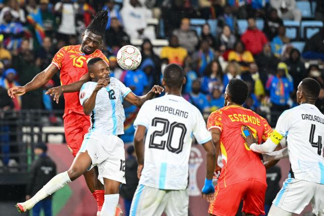 Democratic Republic Of Congo's defender #15 Rocky Bushiri and Botswana's defender #12 Mothusi Johnson vie during the Africa Cup of Nations (CAN) Group D football match between Botswana and Democratic Republic of Congo at El Madina Stadium in Rabat on December 30, 2025. (Photo by SEBASTIEN BOZON / AFP)