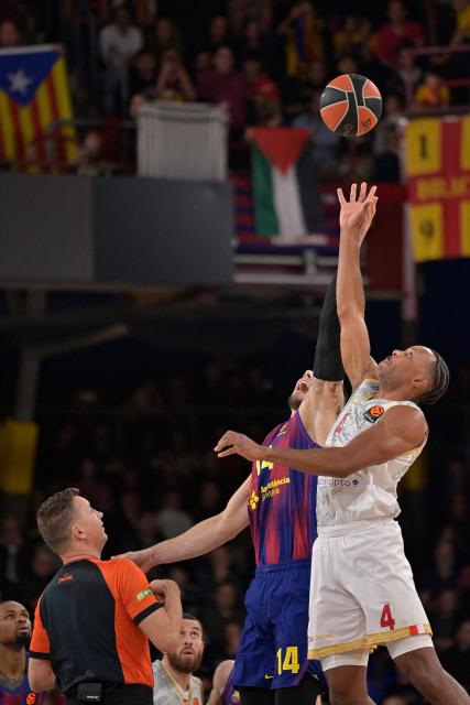 Barcelona's Spanish center #14 Willy Hernangomez and AS Monaco's American forward #04 Jaron Blossomgame fight for the ball during the Euroleague basketball between FC Barcelona and Monaco at Palau Blaugrana Arena in Barcelona, Spain on December 30, 2025. (Photo by MANAURE QUINTERO / AFP)
