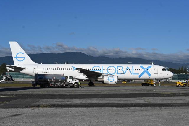 An airliner carrying Guatemalan migrants deported from the United States is pictured on the runway at the Guatemalan Air Force Base in Guatemala City on December 30, 2025, during the last deportee flight of the year. (Photo by Johan ORDONEZ / AFP)