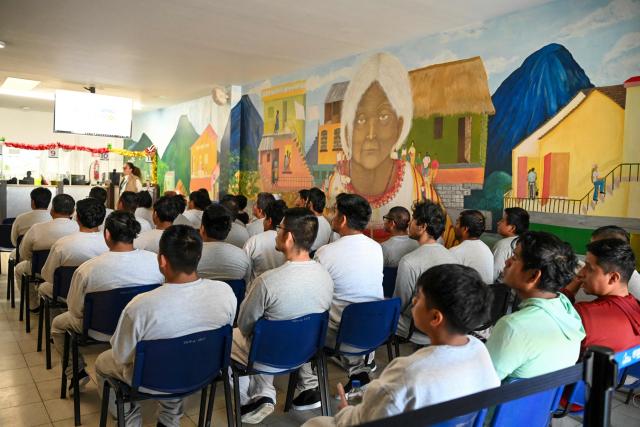 Guatemalan migrants deported from the United States wait to receive assistance at the Returnee Reception Center upon arrival at the Guatemalan Air Force Base in Guatemala City on December 30, 2025, during the last deportee flight of the year. (Photo by Johan ORDONEZ / AFP)