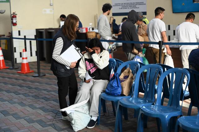 A Guatemalan migrant deported from the United States cries as she receives assistance at the Returnee Reception Center upon her arrival at the Guatemalan Air Force Base in Guatemala City on December 30, 2025, during the last deportee flight of the year. (Photo by Johan ORDONEZ / AFP)