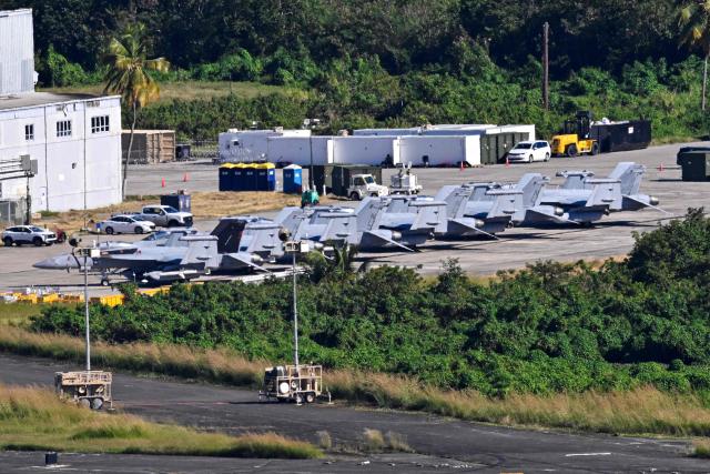 US military fighter jets sit on the tarmac at José Aponte de la Torre Airport, formerly Roosevelt Roads Naval Station, on December 30, 2025 in Ceiba, Puerto Rico. The United States has deployed a major military force in the Caribbean and has recently intercepted oil tankers as part of a naval blockade against Venezuelan vessels it considers to be under sanctions. Since September, US forces have launched dozens of air strikes on boats that Washington alleges, without showing evidence, were transporting drugs. More than 100 people have been killed. (Photo by Miguel J. Rodriguez Carrillo / AFP)