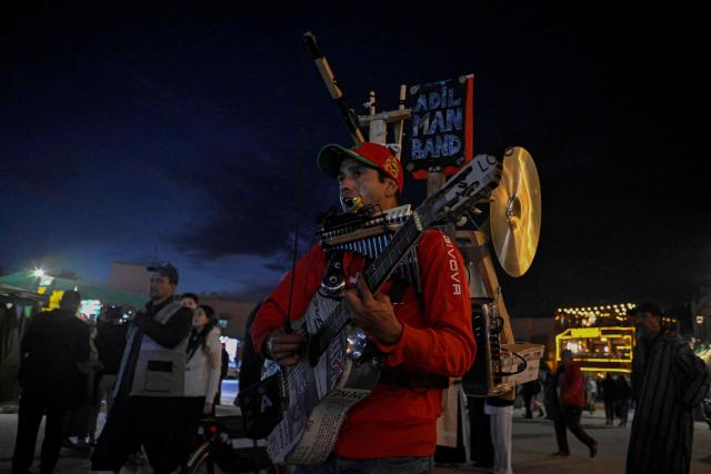 A street musician performs in the Jemaa el-Fnaa square in Marrakesh on December 30, 2025. (Photo by Khaled DESOUKI / AFP)