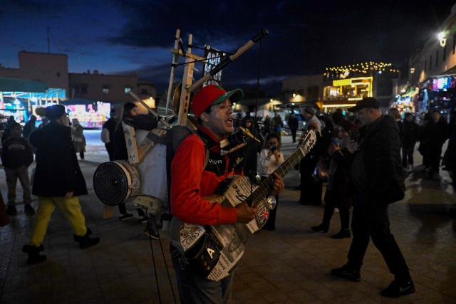 A street musician performs in the Jemaa el-Fnaa square in Marrakesh on December 30, 2025. (Photo by Khaled DESOUKI / AFP)