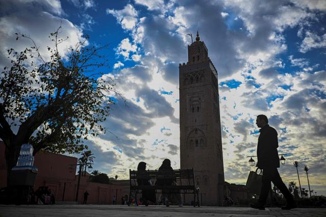 A man walks near the Koutoubia Mosque in Marrakesh on December 30, 2025. (Photo by Khaled DESOUKI / AFP)