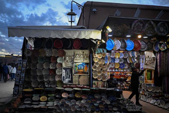 A Moroccan man waits for customers at his shop in the Jemaa el-Fnaa square in Marrakesh on December 30, 2025. (Photo by Khaled DESOUKI / AFP)