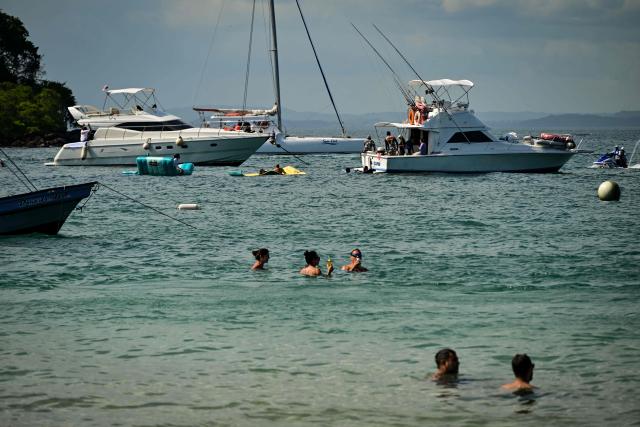 Tourists enjoy Taboga Island, located on the Pacific side in the Gulf of Panama and 20 km from Panama City, on December 30, 2025. (Photo by MARTIN BERNETTI / AFP)