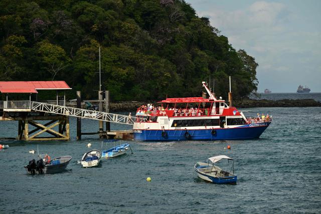 Tourists in a boat enjoy Taboga Island, located on the Pacific side in the Gulf of Panama and 20 km from Panama City, on December 30, 2025. (Photo by MARTIN BERNETTI / AFP)