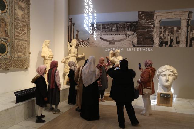 Libyan families and students visit the National Museum after its reopening, following a closure of more than a decade in the Libyan capital Tripoli on December 23, 2025. In a historic building in central Tripoli, Libyans wander past ancient statues and artefacts, rediscovering a heritage that transcends political divides at their national museum which reopened this month after a 2011 uprising. (Photo by Mahmud Turkia / AFP)