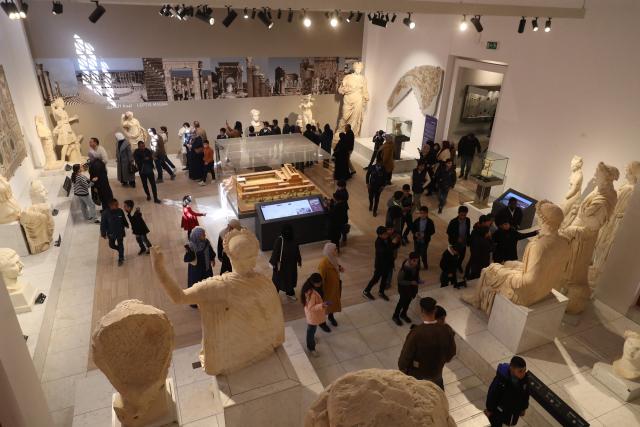 Libyan families and students visit the National Museum after its reopening, following a closure of more than a decade in the Libyan capital Tripoli on December 23, 2025. In a historic building in central Tripoli, Libyans wander past ancient statues and artefacts, rediscovering a heritage that transcends political divides at their national museum which reopened this month after a 2011 uprising. (Photo by Mahmud Turkia / AFP)