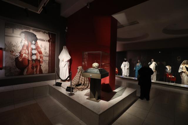 People visit the National Museum after its reopening, following a closure of more than a decade in the Libyan capital Tripoli on December 23, 2025. In a historic building in central Tripoli, Libyans wander past ancient statues and artefacts, rediscovering a heritage that transcends political divides at their national museum which reopened this month after a 2011 uprising. (Photo by Mahmud Turkia / AFP)