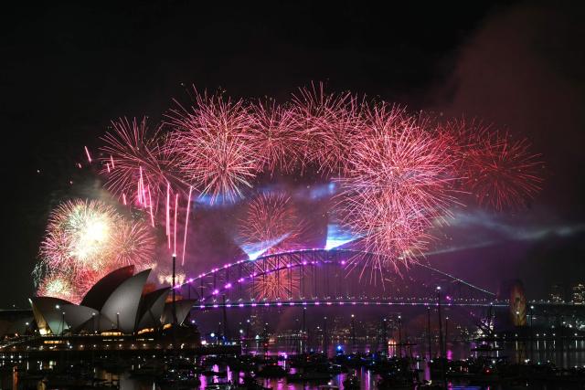 Fireworks light up the midnight sky over Sydney Harbour Bridge and Sydney Opera House during New Year’s Day celebrations in Sydney on January 1, 2026. (Photo by Saeed KHAN / AFP)