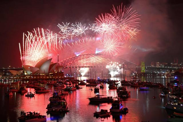 Fireworks light up the midnight sky over Sydney Harbour Bridge and Sydney Opera House during New Year’s Day celebrations in Sydney on January 1, 2026. (Photo by Saeed KHAN / AFP)