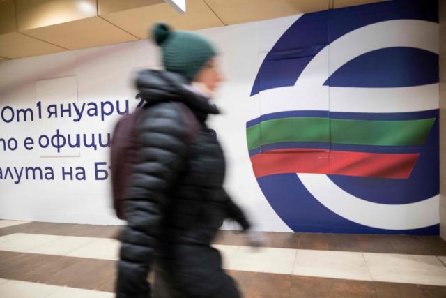 A commuter walks past an advertisement promoting Bulgaria's entry into the Eurozone in Sofia's subway on December 31, 2025, ahead of the country's adoption of the euro on January 1, 2026. (Photo by Nikolay DOYCHINOV / AFP)
