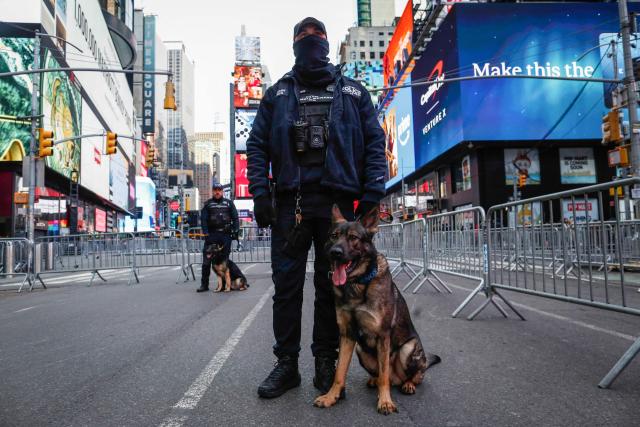 Members of the New York City Police Department (NYPD) stand watch ahead of tonight's New Year's Eve celebrations in Times Square, New York on December 31, 2025. (Photo by Kena BETANCUR / AFP)