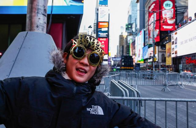 A tourist from Japan wears New Year's themed glasses ahead of tonight's New Year's Eve celebrations in Times Square, New York on December 31, 2025. (Photo by Kena BETANCUR / AFP)