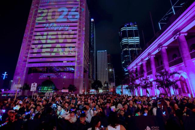 Revellers celebrate the New Year during Hong Kong's countdown celebrations in Central, Hong Kong, on December 31, 2025. (Photo by May JAMES / AFP)