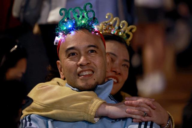 Revellers wait for the midnight countdown during Hong Kong's New Year celebrations in Central, Hong Kong, on December 31, 2025. (Photo by May JAMES / AFP)