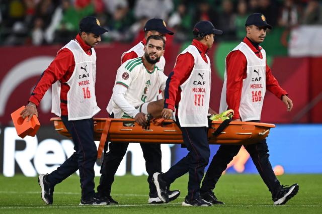 Algeria's defender #4 Mohamed Amine Tougai is evacuated on a stretcher during the Africa Cup of Nations (CAN) Group E football match between Equatorial Guinea and Algeria at Moulay Hassan Stadium in Rabat on December 31, 2025. (Photo by Paul ELLIS / AFP)