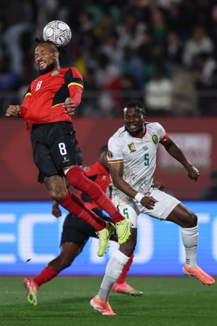Mozambique's defender #08 Edmilson Dove (L) fights for the ball with Cameroon's defender #05 Nouhou (R) during the Africa Cup of Nations (CAN) Group F football match between Mozambique and Cameroon at the Grand Stadium in Agadir on December 31, 2025. (Photo by FRANCK FIFE / AFP)